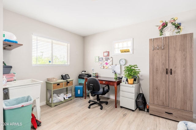 office space featuring baseboards and light wood-style flooring