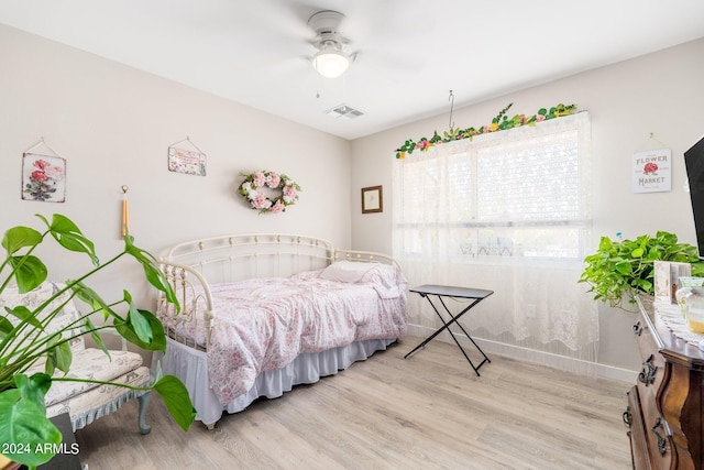 bedroom with light hardwood / wood-style flooring and ceiling fan