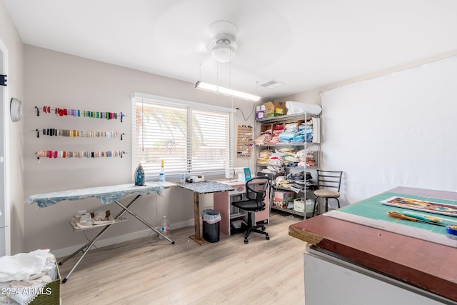 home office with ceiling fan, visible vents, and wood finished floors