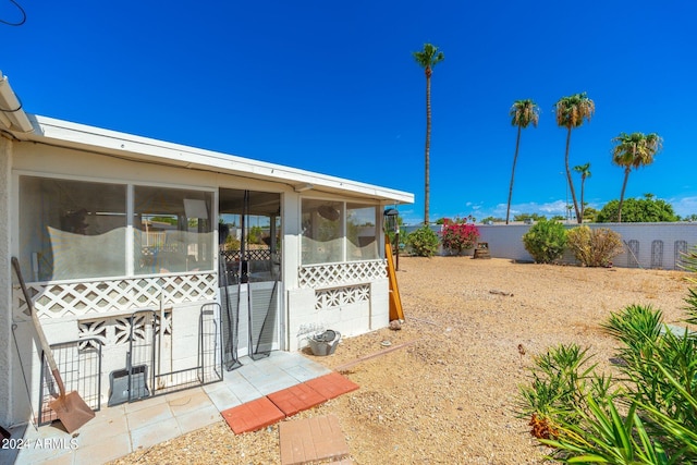 view of yard featuring a fenced backyard and a sunroom