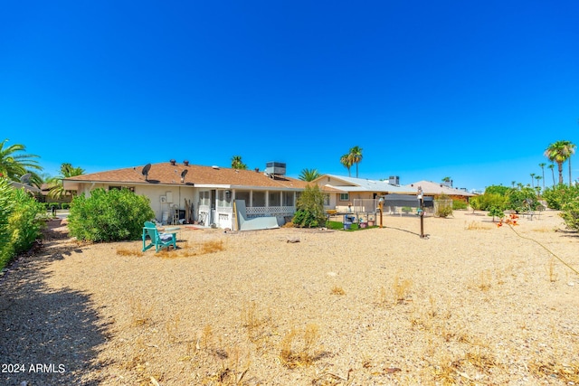 rear view of property with a sunroom