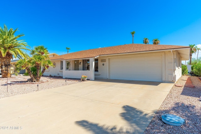 ranch-style house featuring stucco siding, concrete driveway, and an attached garage