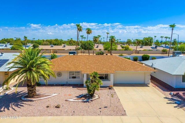 single story home featuring a garage and driveway