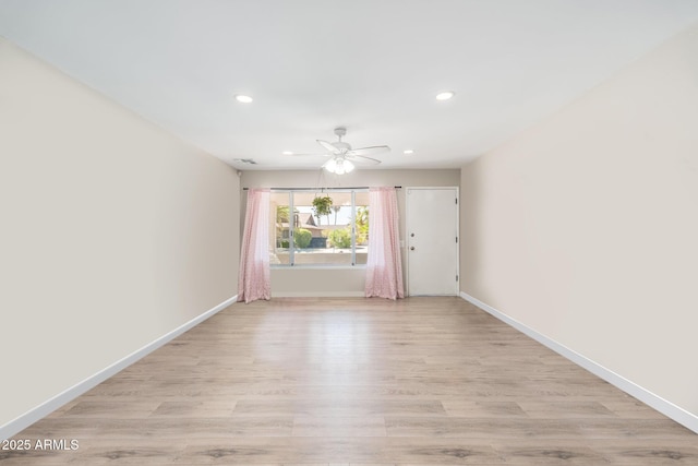 spare room featuring recessed lighting, baseboards, light wood-style flooring, and ceiling fan