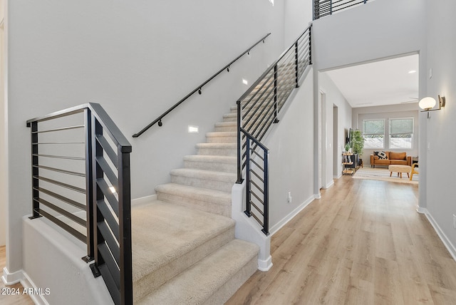 stairs featuring hardwood / wood-style flooring