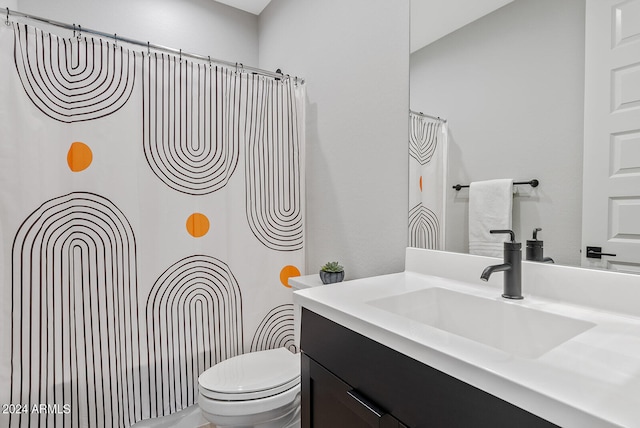 bathroom featuring vanity and toilet