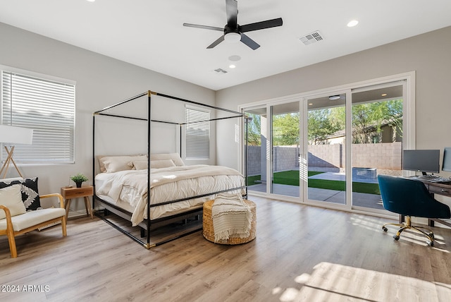 bedroom featuring ceiling fan, light hardwood / wood-style floors, and access to exterior