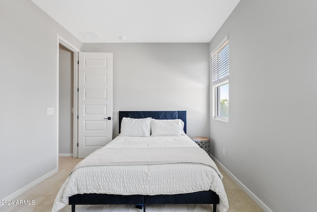 bedroom featuring light colored carpet