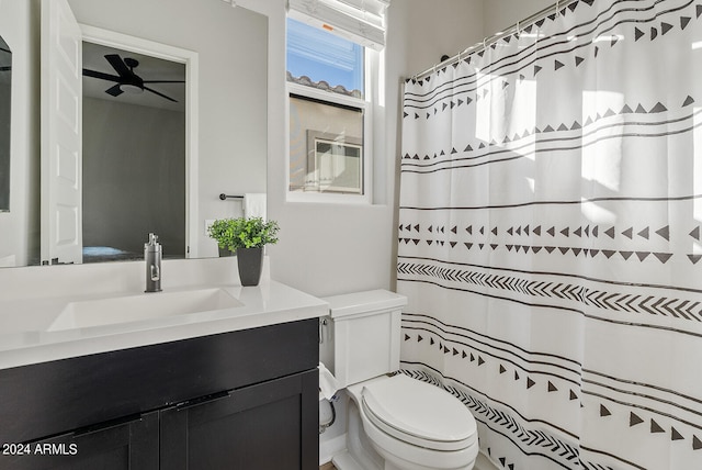 bathroom with curtained shower, vanity, and toilet