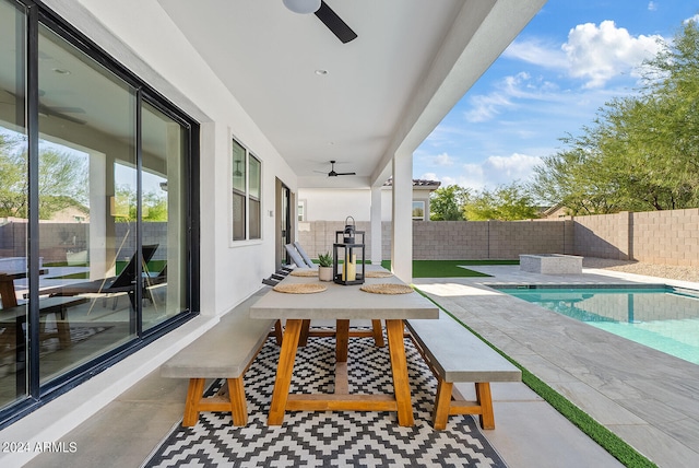 view of patio / terrace featuring ceiling fan and a fenced in pool