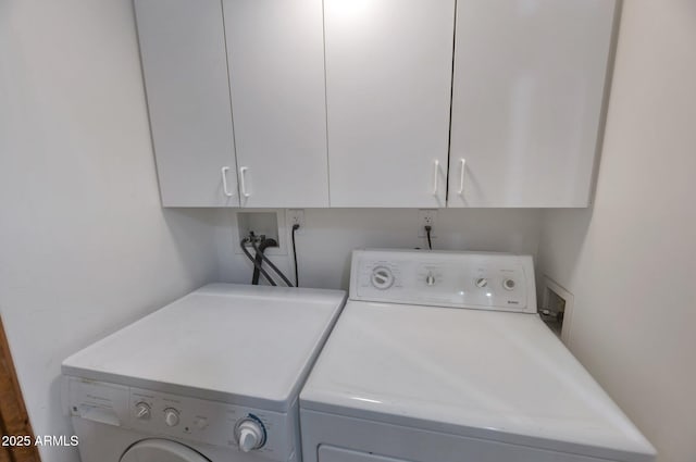 clothes washing area featuring cabinets and washing machine and dryer