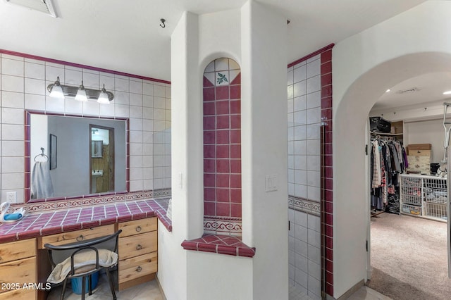 bathroom with tile walls