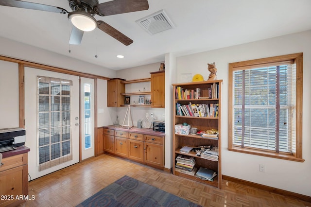 kitchen featuring ceiling fan and light parquet flooring