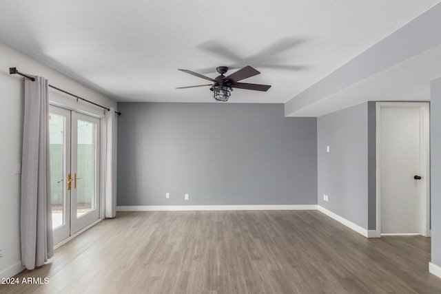 empty room featuring hardwood / wood-style flooring, ceiling fan, and french doors