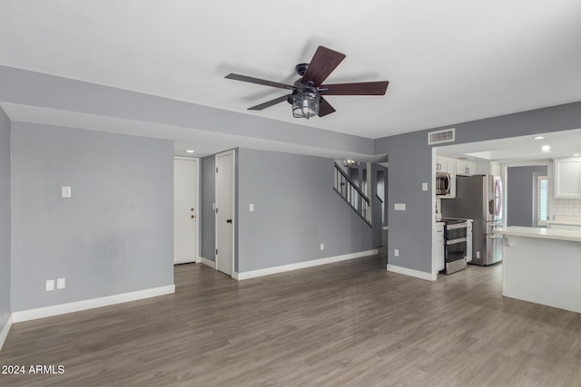 unfurnished living room with hardwood / wood-style flooring and ceiling fan