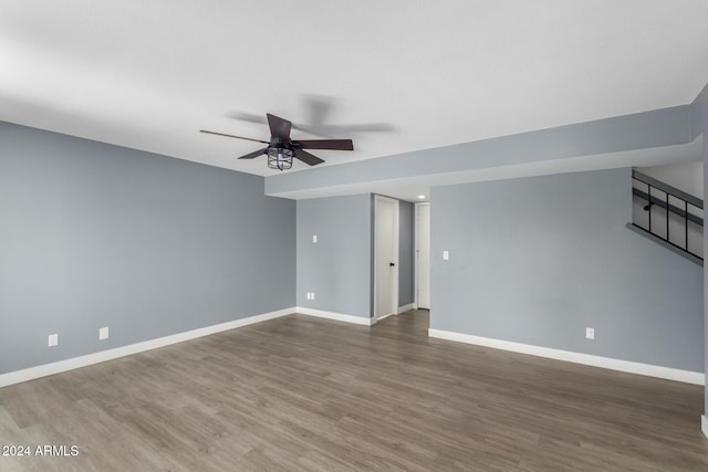 unfurnished room with ceiling fan and dark hardwood / wood-style flooring