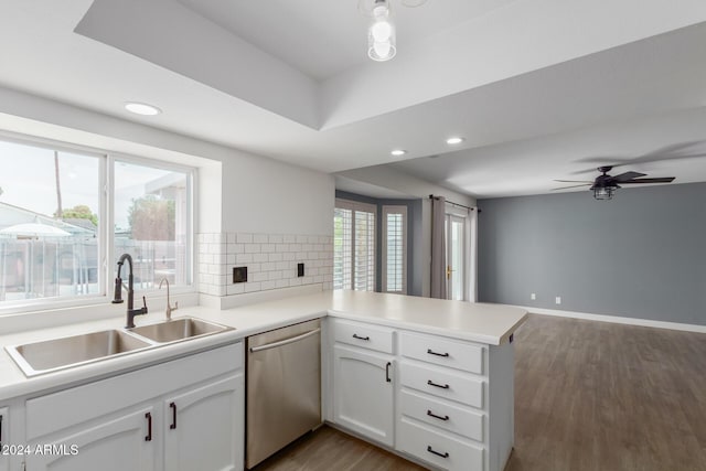 kitchen featuring ceiling fan, sink, stainless steel dishwasher, kitchen peninsula, and white cabinets