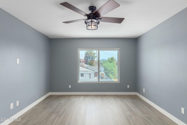 empty room featuring ceiling fan and light hardwood / wood-style floors