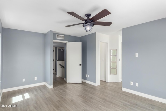 unfurnished bedroom with ceiling fan and light hardwood / wood-style flooring