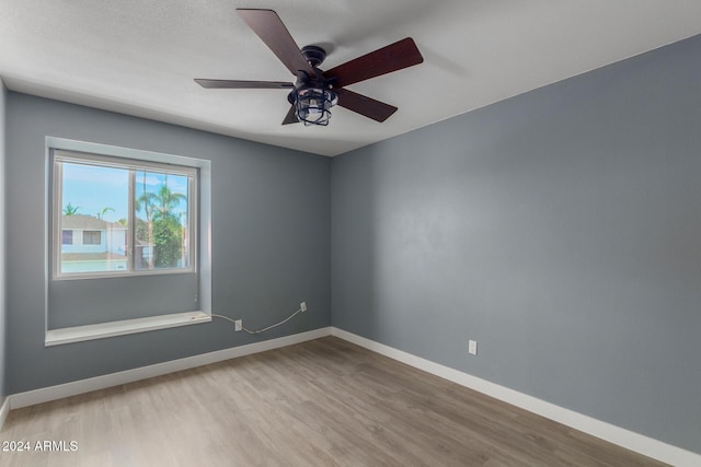 empty room with light hardwood / wood-style floors and ceiling fan