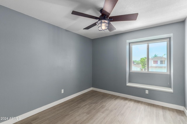 unfurnished room with ceiling fan and light wood-type flooring