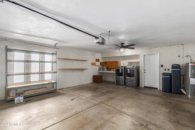 garage featuring electric water heater, a garage door opener, ceiling fan, and washing machine and clothes dryer