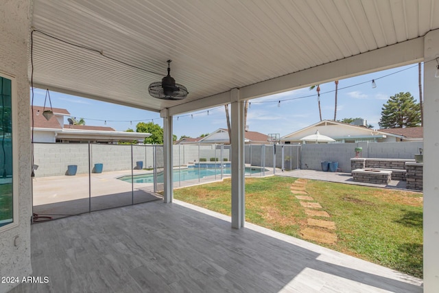 view of patio / terrace with a fenced in pool and ceiling fan