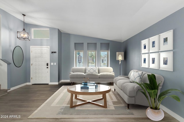 living room with a chandelier, wood-type flooring, and vaulted ceiling