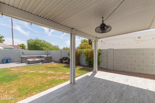 view of patio featuring a fire pit and ceiling fan