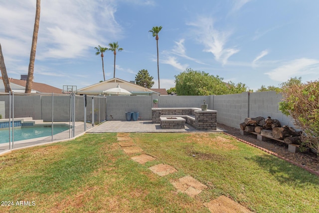 view of yard featuring a fire pit, a fenced in pool, and a patio