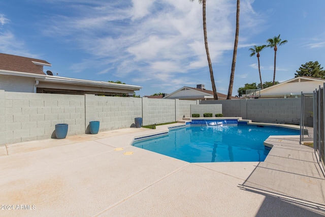 view of pool with pool water feature and a patio