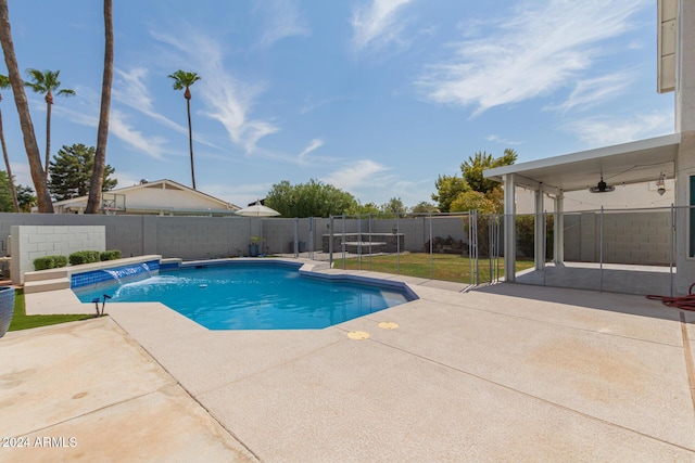 view of swimming pool featuring pool water feature, ceiling fan, and a patio area