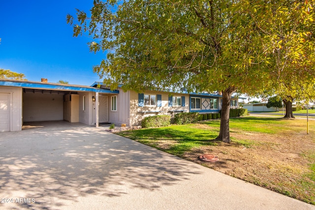 view of front facade with a front lawn and a carport