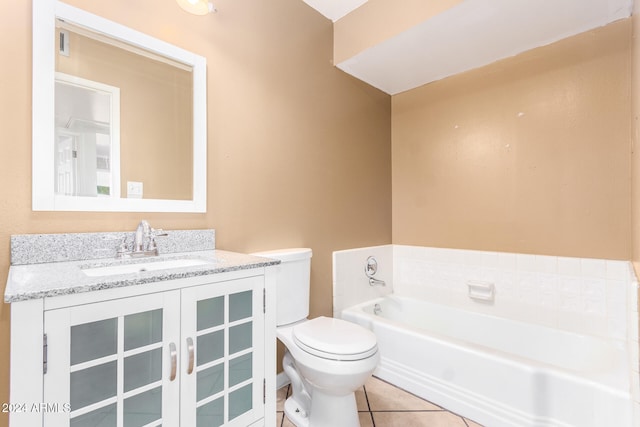 bathroom with tile patterned flooring, vanity, toilet, and a bathtub