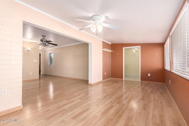 unfurnished living room featuring ceiling fan, light wood-type flooring, and vaulted ceiling