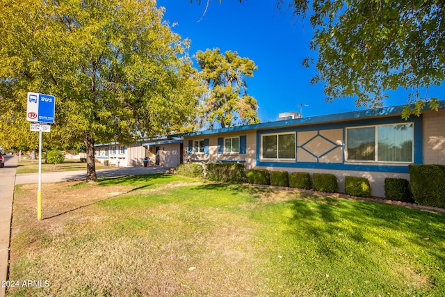 ranch-style house with a front lawn