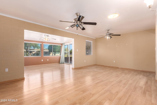 empty room with light hardwood / wood-style flooring, ceiling fan, and crown molding