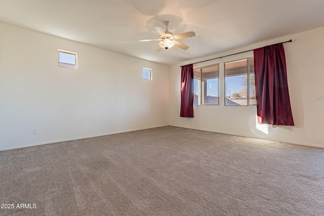 spare room featuring ceiling fan, plenty of natural light, and carpet flooring