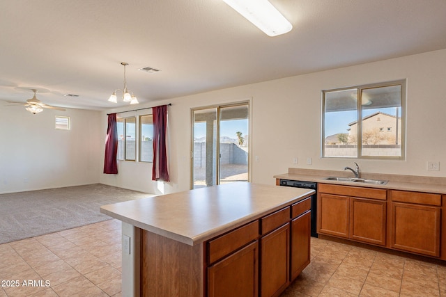 kitchen with ceiling fan with notable chandelier, pendant lighting, dishwasher, a center island, and sink