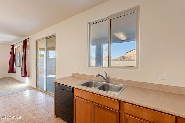 kitchen featuring sink, black dishwasher, and light tile patterned flooring