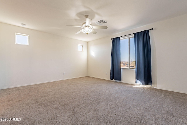 carpeted empty room featuring ceiling fan