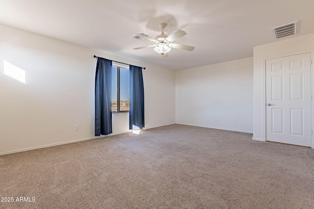 carpeted spare room with ceiling fan