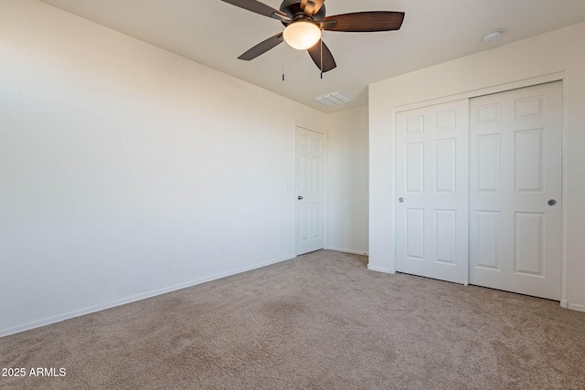 unfurnished bedroom with ceiling fan, a closet, and light colored carpet