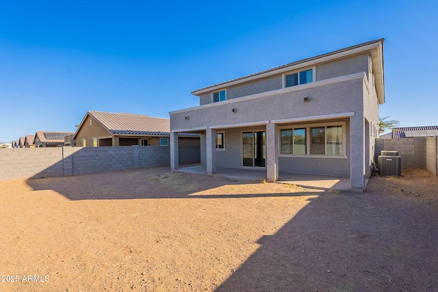 rear view of property featuring central AC unit and a patio