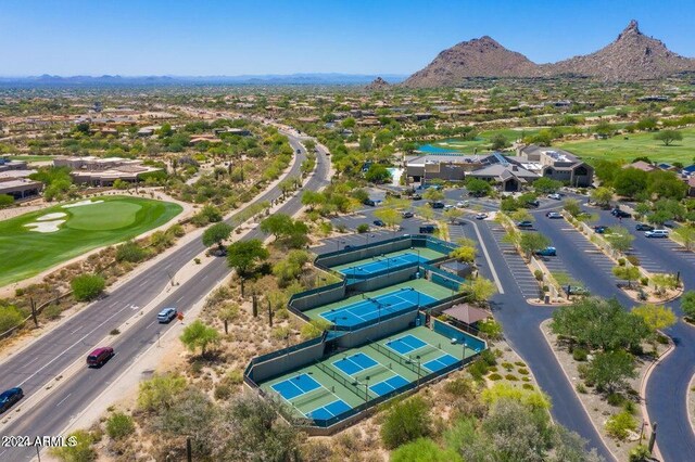 birds eye view of property with view of golf course and a mountain view