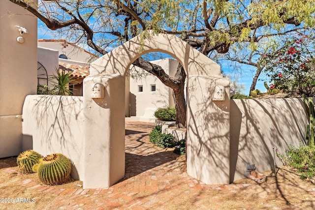 exterior space featuring a fenced front yard and stucco siding