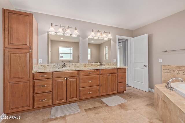 3034 E Turney Ave, Phoenix, AZ 85016 - bathroom featuring double vanity, a garden tub, and baseboards