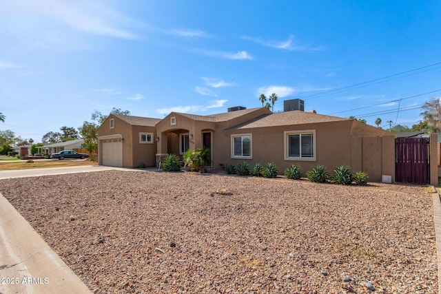 3034 E Turney Ave, Phoenix, AZ 85016 - view of front facade with an attached garage, concrete driveway, stucco siding, and cooling unit