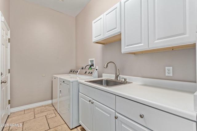 3034 E Turney Ave, Phoenix, AZ 85016 - laundry room with cabinet space, washer and dryer, baseboards, and stone tile flooring