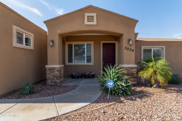 3034 E Turney Ave, Phoenix, AZ 85016 - doorway to property with stone siding and stucco siding